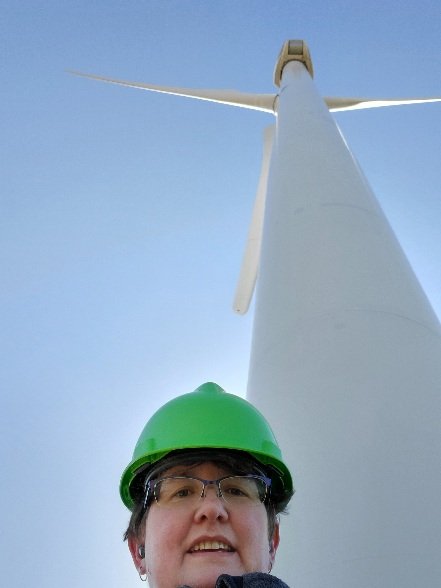 photo of jennifer stucker and a wind turbine
