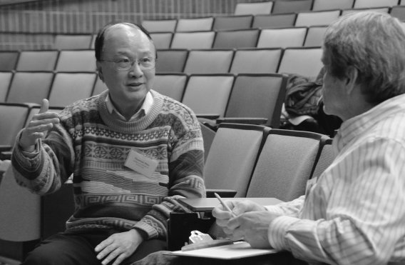 Thomas Hour chatting with another person at the 2023 Riviere Fabes Symposium