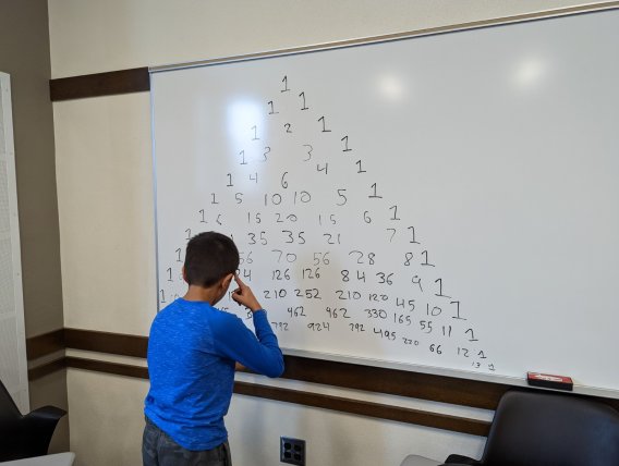 Saturday Morning Math student works at the whiteboard.