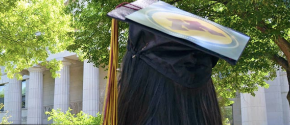 back of head with long hair wearing mortarboard