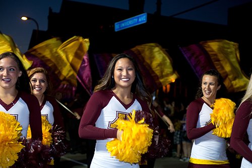 Four women cheerleaders in the Homecoming parade.