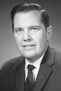 Black and white portrait of Professor Robert Lambert in a dark suit