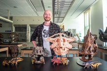 grad student Viktor Radermacher with dinosaur casts