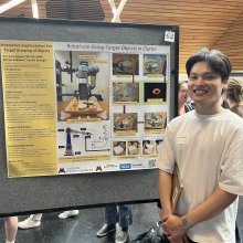 Duc Hoa Nguyen poses in front of their poster