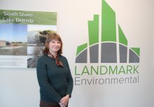 Sherry Van Duyn next to the Landmark Engineering logo