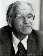 Black and white picture of person with glasses and a suit