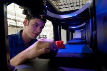 Male student looking at 3D-printed M