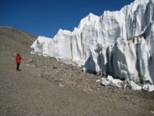 person standing by a glacier