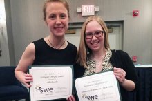 Elia Zanella and Kelsey Harper hold their award certificates at the SWE Region Conference