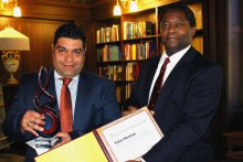 Taha Namazi accepts award from Dean Mukasa