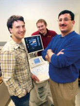 Electrical and computer engineering professor Emad Ebbing and research assistants Andrew Casper and John Ballard pose with sonogram machine