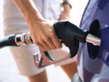 close up of man filling up car with gas