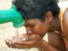 Child drinking water from a well