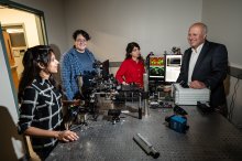 Taner Akkin and labmates using advanced imaging technology in the lab
