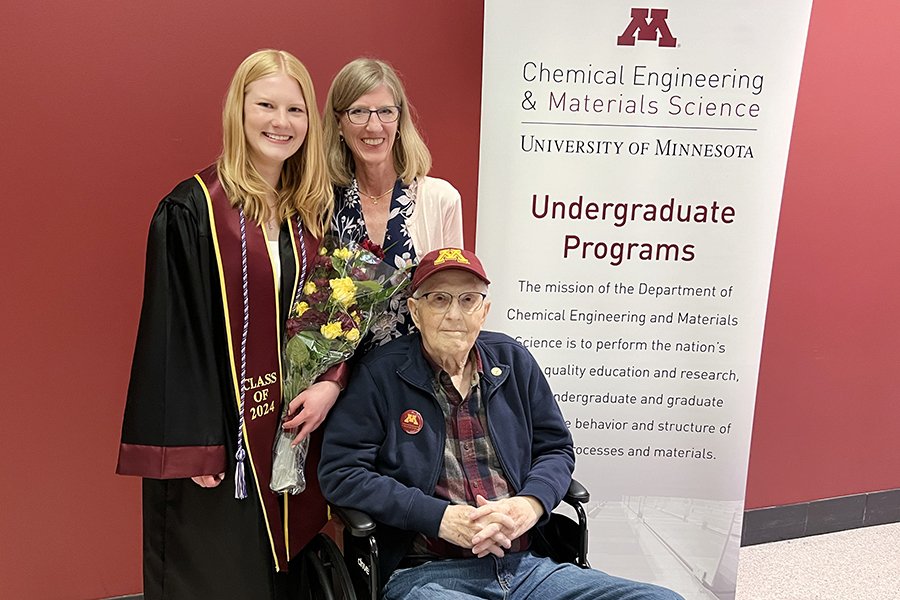 Three generations of CSE alumni in front of a CEMS banner