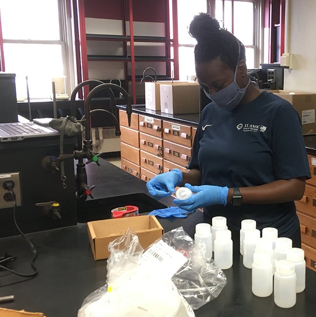 Aminata Dotson helps label chemical bottles