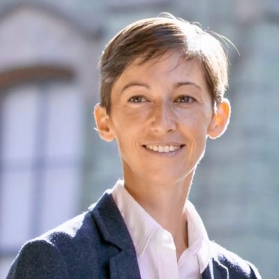 Smiling woman with short hair standing in the sunshine