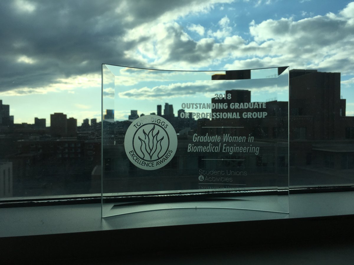 Award in windowsill with skyline in background. Award is 2018 Tony Diggs Excellence Award for Outstanding Graduate or Professional Student Group, awarded to the Graduate Women in Biomedical Engineering (GWBME) student group 