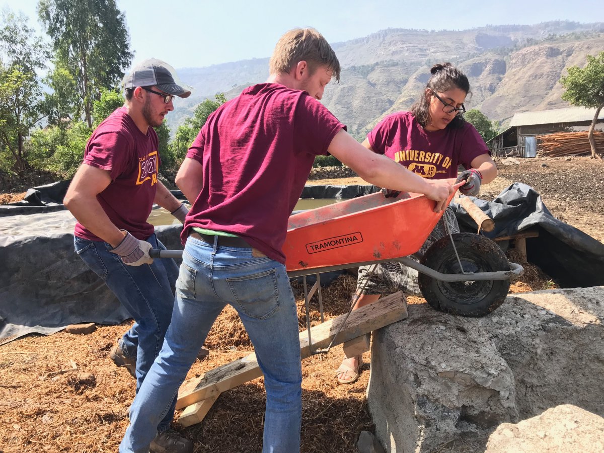 Engineers Without Borders - UMN students working with wheelbarrow