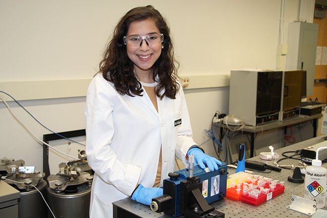 Rebeca Rodriguez, scientist, in lab coat in the lab