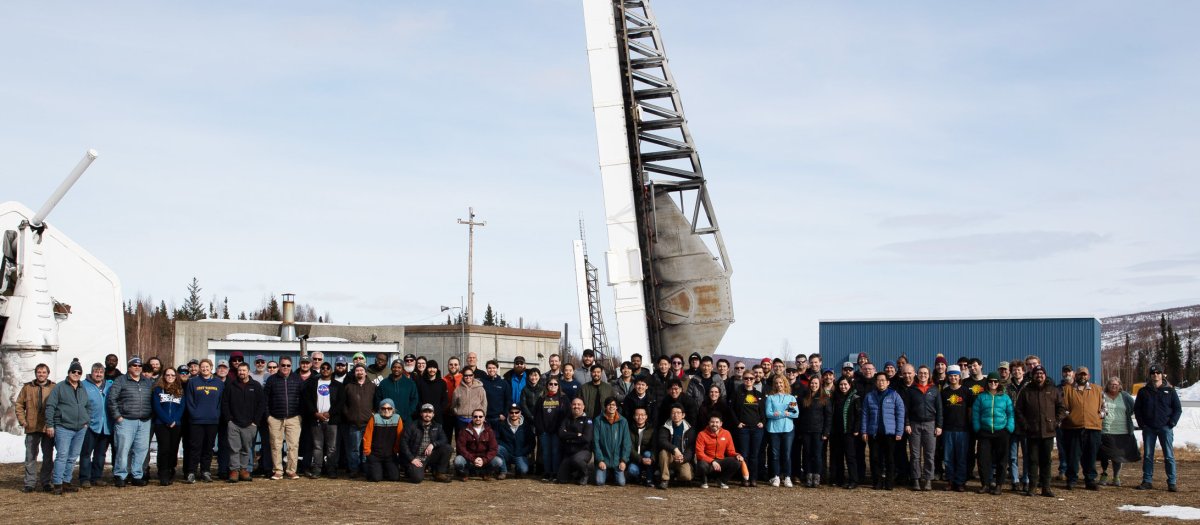 FOSXI research team standing in front of sounding rocket in Alaska.