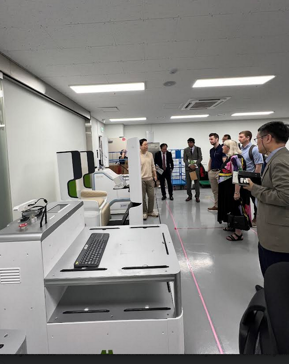 Students looks at equipment in a Korean robotics lab