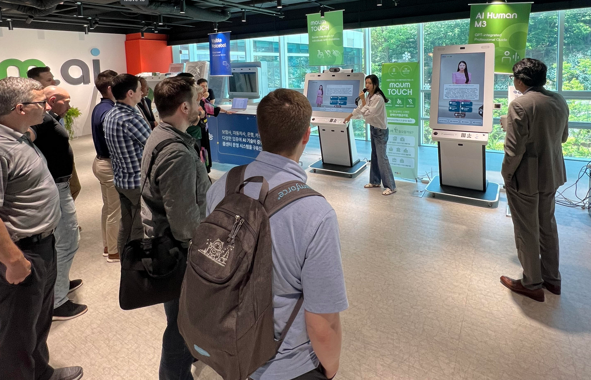 A group of students watch a demo of an AI system