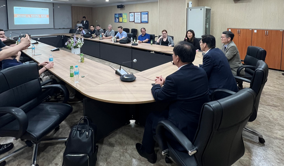 Students at a conference table get a briefing about "Korea's Silicon Valley"