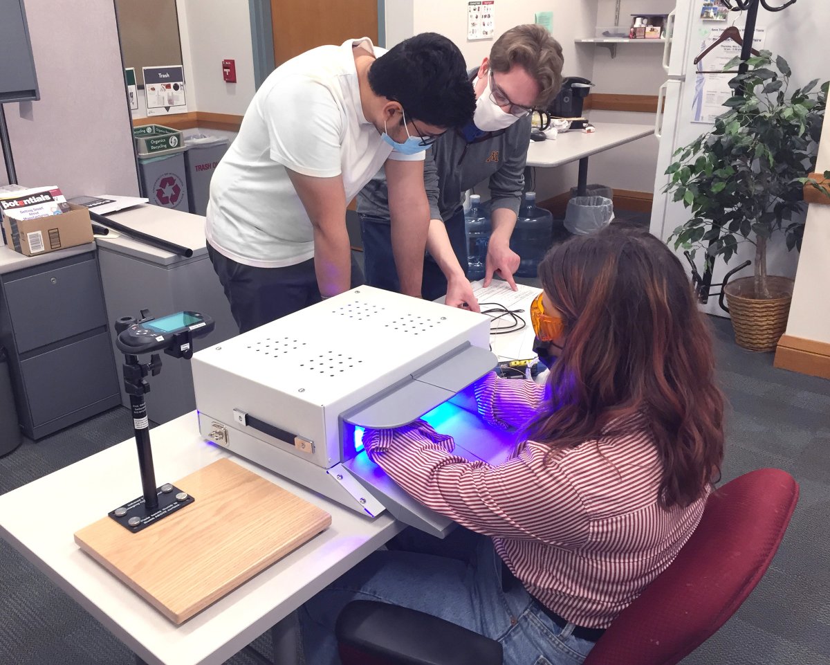 Kushal Sehgal, James Kerber, and Emily Wagner working on the phototherapy device