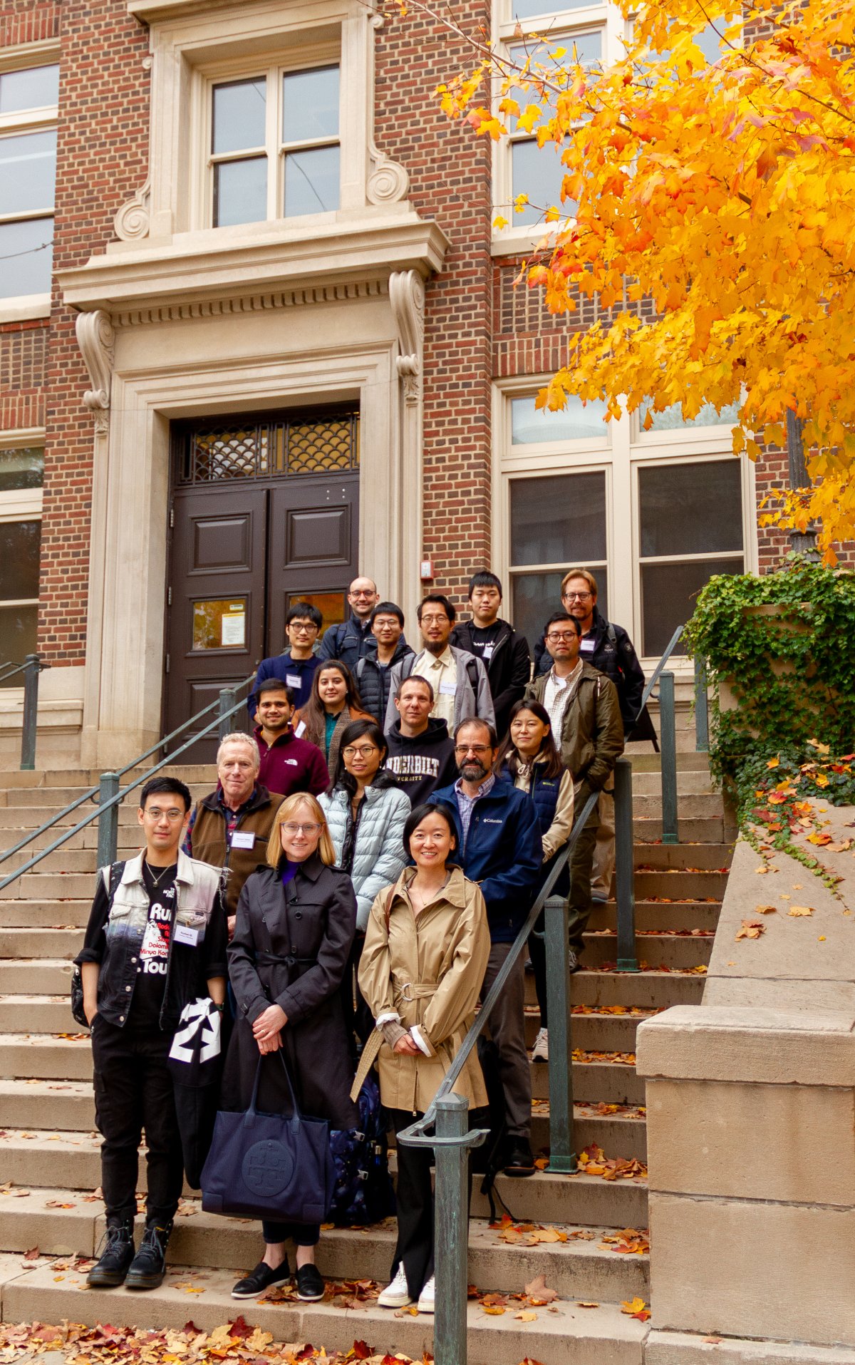 Group of workshop attendees standing on steps in the autumn.