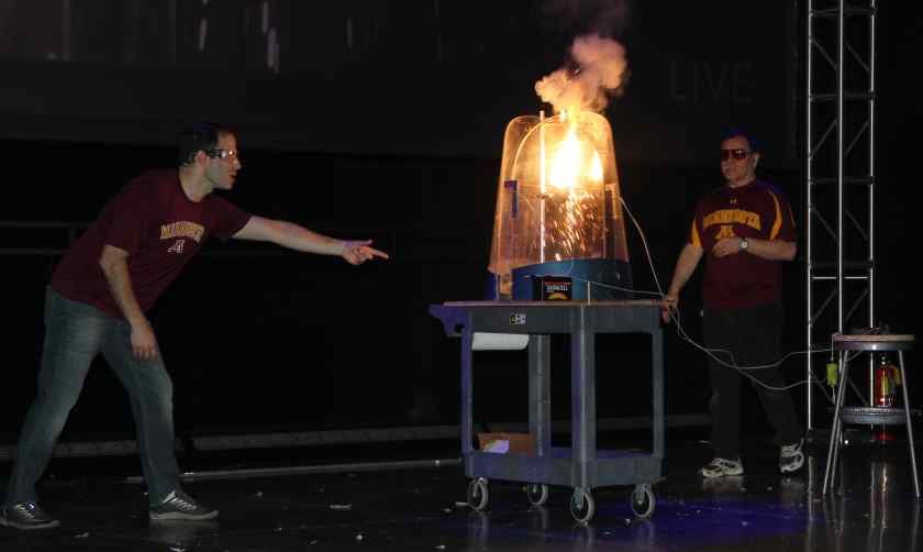 Aaron Massari and Joe Franek create molten iron at Energy & U show.
