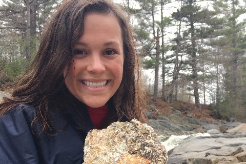 Emily Erhart smiling while holding a rock