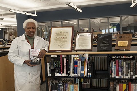 Jeannette Brown holding the book she wrote