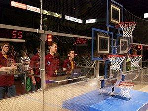 students watching robots playing basketball