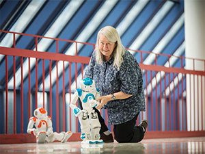 Maria Gini with mini robot in Keller Hall