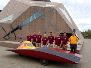 U of M Solar Vehicle Project Team 2010 posing with the solar car