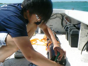 researcher setting up submersible camera