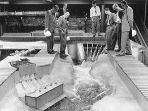black and white photo of engineers and a model of the Mayfield Hydroelectric Dam on the Cowlitz River near Tacoma, Wash