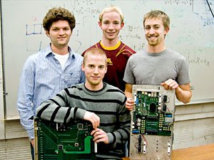 four students holding their design for the world's biggest particle collider