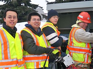 Henry Liu (left) with his research team and a MnDOT technician