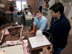 Chris Hogan, center, directs the Nanoparticle Physics Laboratory with a team of researchers including graduate student Abhimanyu Ghosh, right