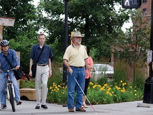 Visually impaired pedestrian walking with cane