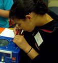 female student participating in technology day camp
