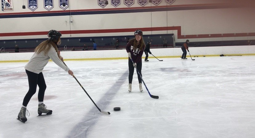 Breanne playing hockey with a blind person
