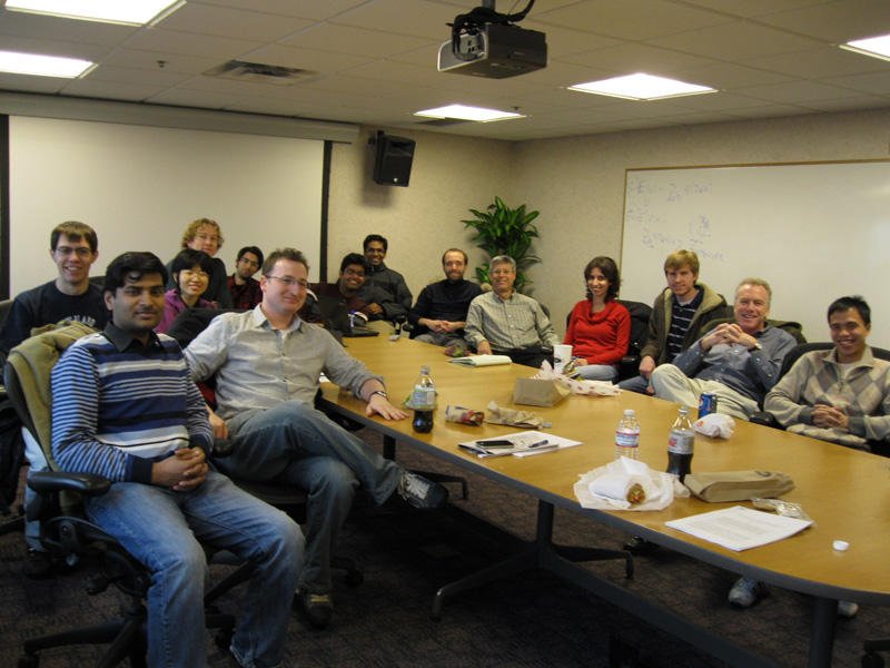 People posing for a photo at a conference table