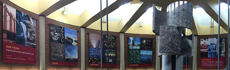 Banners that illustrate CEGE's mission and vision hang in the Charles Fairhurst Rotunda