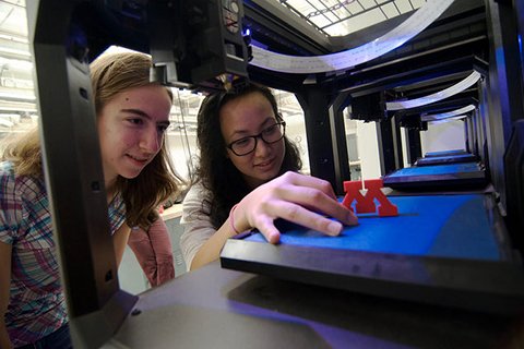 students looking at 3D printed block M