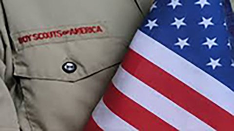 close up of boy scout shirt and US flag