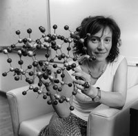 black and white image of CSE Woman faculty member holding up a chemical model