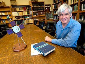 U of M physicist John Wygant sitting at a desk